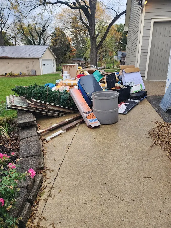 Dumpster being loaded with debris for Roofing Dumpster Rental in Northglenn